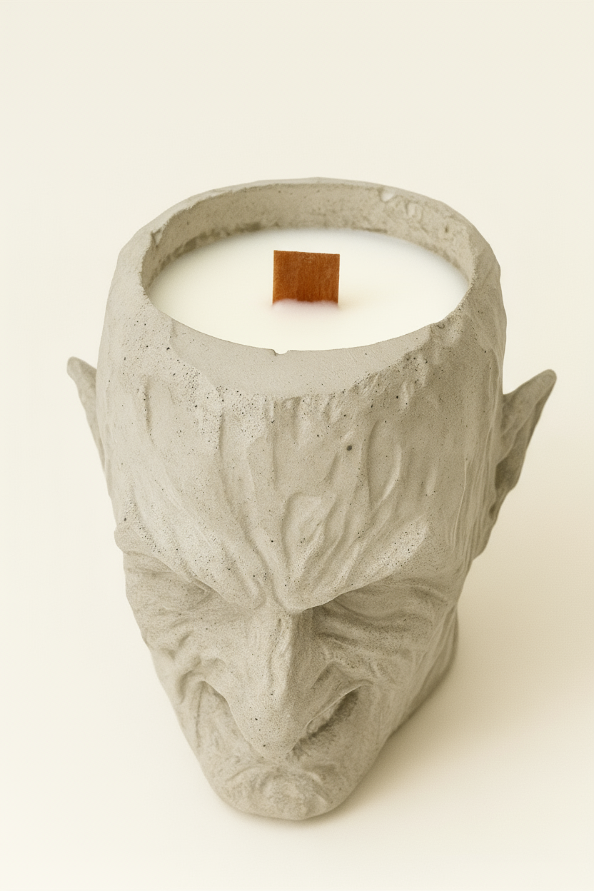 Candle in a concrete mask container on a white background