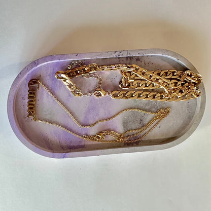 concrete oval shaped trinket tray with jewelry props