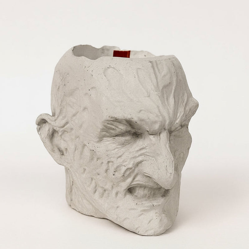 Vase shaped like a face on a white background